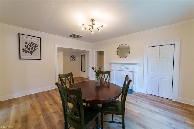 301 S Shaver St, Salisbury, NC 28144 - dining area with a chandelier, light wood-style floors, and crown molding