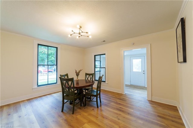 301 S Shaver St, Salisbury, NC 28144 - dining room with ornamental molding, healthy amount of natural light, light wood-style flooring, and a chandelier