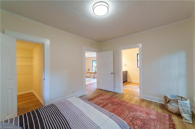 301 S Shaver St, Salisbury, NC 28144 - unfurnished bedroom featuring wood finished floors, ornamental molding, and a textured ceiling