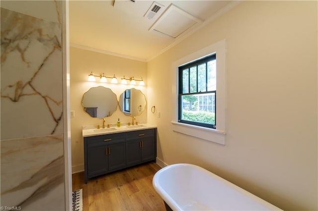 301 S Shaver St, Salisbury, NC 28144 - bathroom with ornamental molding, double vanity, a freestanding tub, and wood finished floors