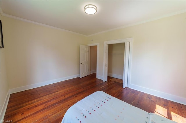 301 S Shaver St, Salisbury, NC 28144 - unfurnished bedroom with dark wood-style floors, ornamental molding, and a closet