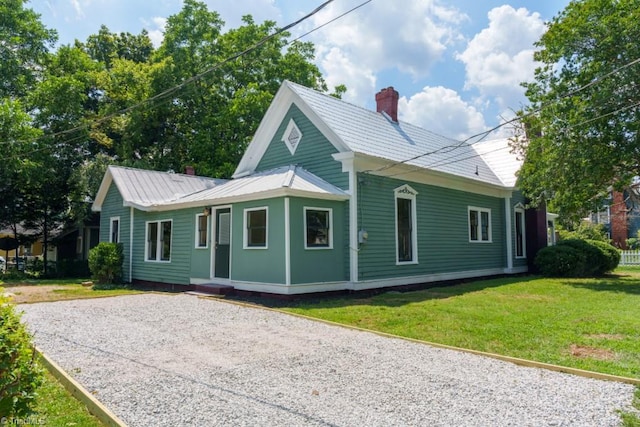 301 S Shaver St, Salisbury, NC 28144 - view of home's exterior with a chimney, a yard, a metal roof, and gravel driveway