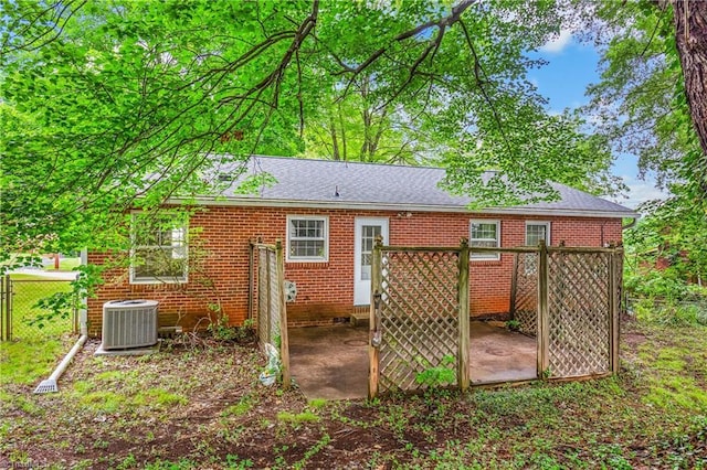 1400 Waybridge Ln, Winston-Salem, NC 27103 - rear view of property with central air condition unit, roof with shingles, brick siding, and a wooden deck