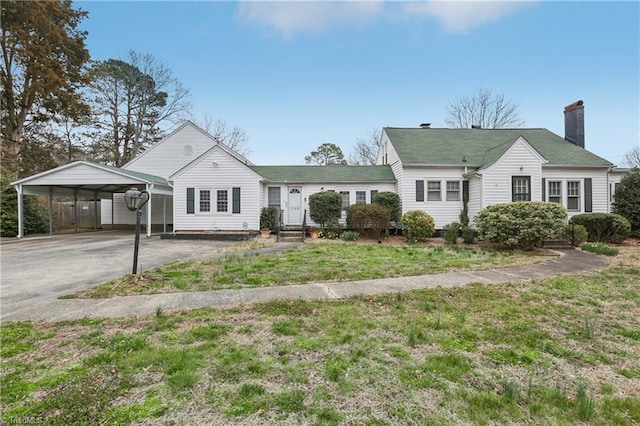 1146 Rogers Rd, Graham, NC 27253 - view of front of home featuring a carport, asphalt driveway, a chimney, and a front yard