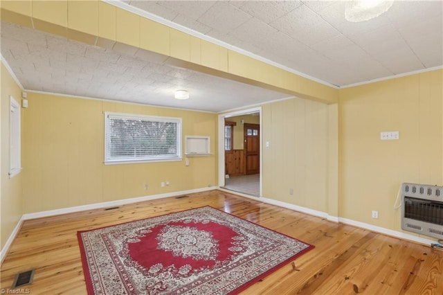 1146 Rogers Rd, Graham, NC 27253 - empty room with heating unit, hardwood / wood-style flooring, ornamental molding, and baseboards