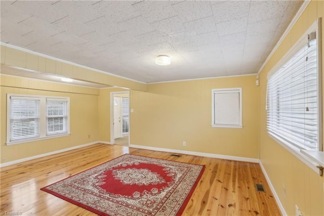 1146 Rogers Rd, Graham, NC 27253 - unfurnished room with wood finished floors, crown molding, and baseboards