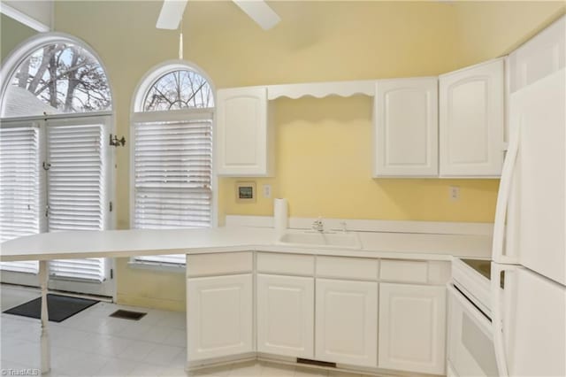 1146 Rogers Rd, Graham, NC 27253 - kitchen featuring a sink, white appliances, a ceiling fan, white cabinetry, and light countertops