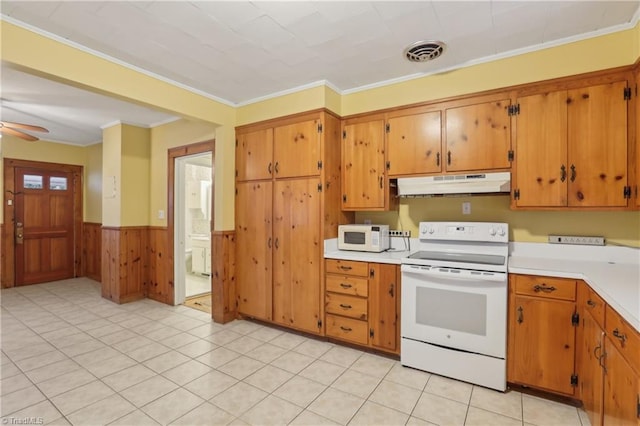 1146 Rogers Rd, Graham, NC 27253 - kitchen featuring white appliances, under cabinet range hood, light countertops, ornamental molding, and wainscoting