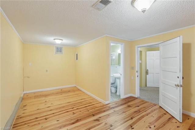 1146 Rogers Rd, Graham, NC 27253 - empty room with light wood-style floors, crown molding, a textured ceiling, and baseboards
