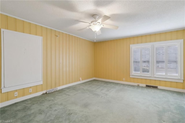 1146 Rogers Rd, Graham, NC 27253 - carpeted spare room featuring a ceiling fan, a textured ceiling, crown molding, and baseboards