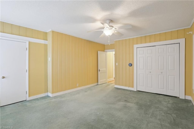 1146 Rogers Rd, Graham, NC 27253 - unfurnished bedroom with carpet, baseboards, ceiling fan, crown molding, and a textured ceiling