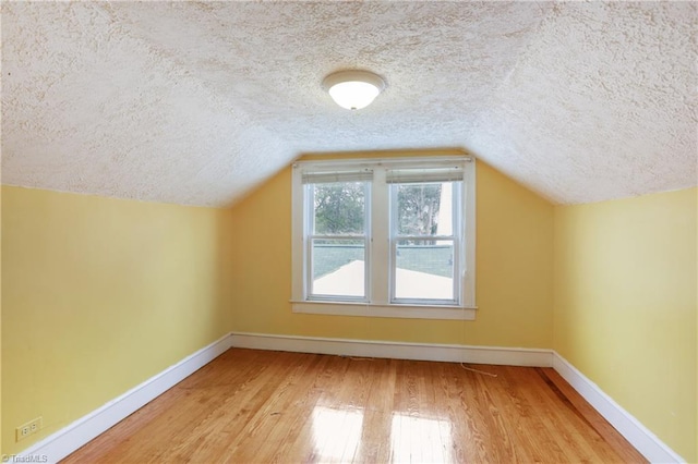 1146 Rogers Rd, Graham, NC 27253 - additional living space with a textured ceiling, wood finished floors, baseboards, and vaulted ceiling