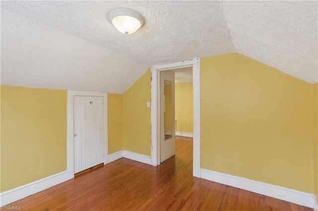 1146 Rogers Rd, Graham, NC 27253 - bonus room with a textured ceiling, baseboards, wood finished floors, and lofted ceiling