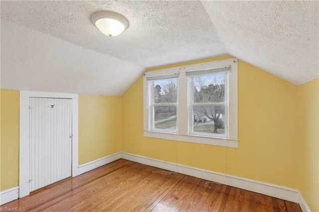 1146 Rogers Rd, Graham, NC 27253 - bonus room with a textured ceiling, baseboards, wood finished floors, and lofted ceiling