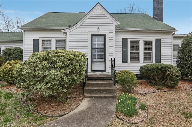 1146 Rogers Rd, Graham, NC 27253 - view of front of house featuring a chimney and roof with shingles