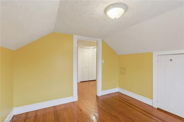 1146 Rogers Rd, Graham, NC 27253 - bonus room featuring a textured ceiling, hardwood / wood-style flooring, baseboards, and vaulted ceiling