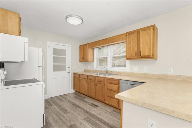 225 Harper St, Winston-Salem, NC 27104 - kitchen with white appliances, light wood finished floors, light countertops, and brown cabinetry