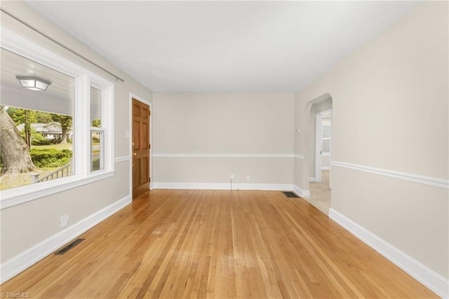 225 Harper St, Winston-Salem, NC 27104 - empty room with arched walkways and light wood-style floors