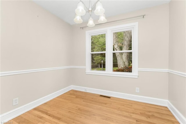225 Harper St, Winston-Salem, NC 27104 - spare room with a chandelier and light wood-style flooring