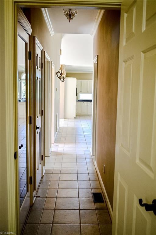 590 Turner Mountain Rd, Mount Airy, NC 27030 - hallway featuring tile patterned floors, crown molding, and a chandelier