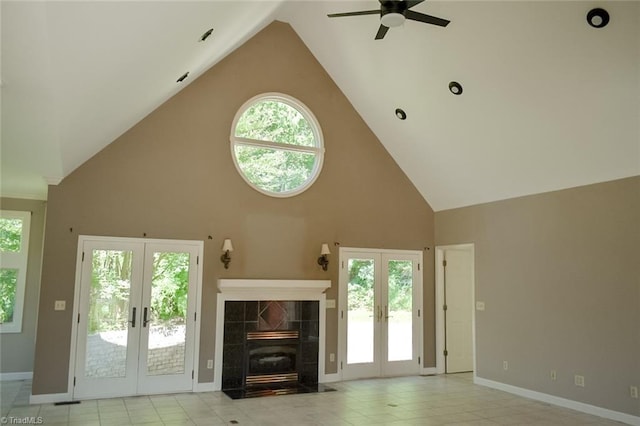 590 Turner Mountain Rd, Mount Airy, NC 27030 - unfurnished living room with french doors, high vaulted ceiling, ceiling fan, a tiled fireplace, and light tile patterned floors