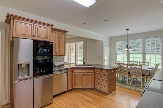 160 Serenity Pointe Dr, Kernersville, NC 27284 - kitchen featuring appliances with stainless steel finishes, a peninsula, light wood-style flooring, a chandelier, and recessed lighting