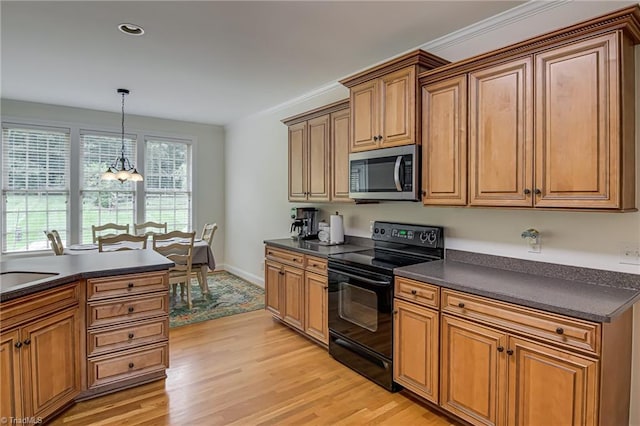 160 Serenity Pointe Dr, Kernersville, NC 27284 - kitchen with stainless steel microwave, black range with electric stovetop, dark countertops, light wood-style floors, and recessed lighting