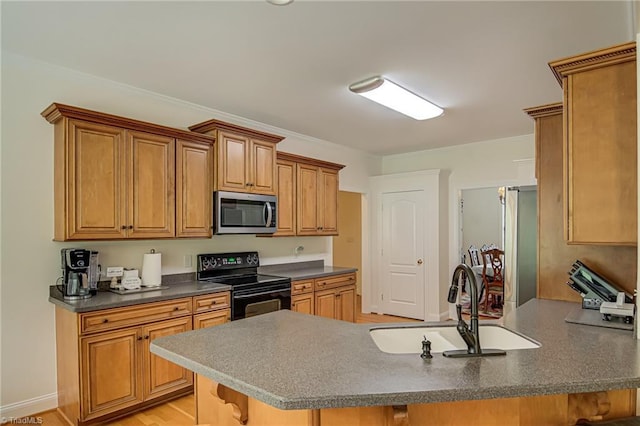 160 Serenity Pointe Dr, Kernersville, NC 27284 - kitchen with stainless steel microwave, black / electric stove, a peninsula, dark countertops, and brown cabinetry
