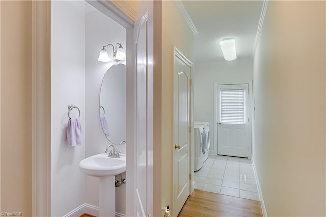160 Serenity Pointe Dr, Kernersville, NC 27284 - bathroom featuring separate washer and dryer, ornamental molding, and wood finished floors