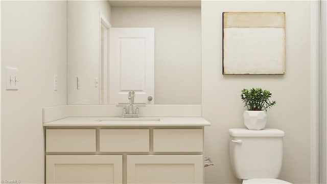 bathroom with toilet and vanity