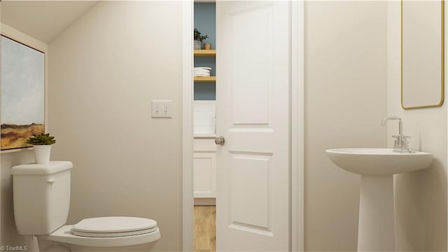 half bath with toilet and vaulted ceiling