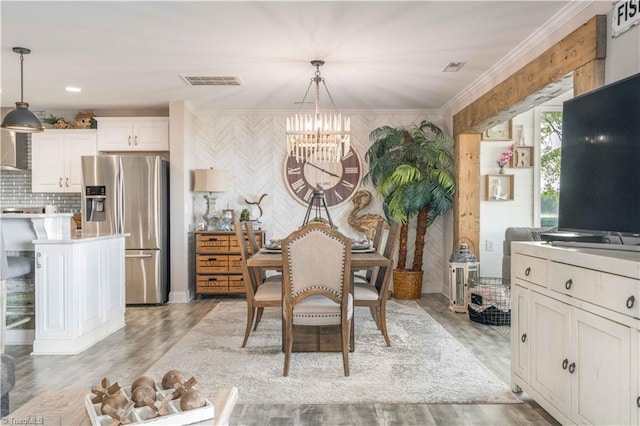 440 Sportsman Dr, Salisbury, NC 28146 - dining area featuring crown molding, a notable chandelier, light wood-style floors, and visible vents