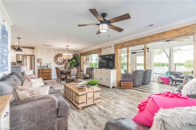 440 Sportsman Dr, Salisbury, NC 28146 - living room with ornamental molding, visible vents, light wood-style flooring, and ceiling fan with notable chandelier