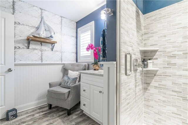 440 Sportsman Dr, Salisbury, NC 28146 - full bathroom featuring wood finished floors, a shower stall, a wainscoted wall, and vanity