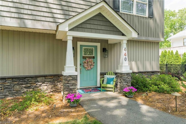 440 Sportsman Dr, Salisbury, NC 28146 - doorway to property with fence, a porch, and stone siding