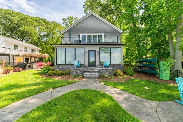 440 Sportsman Dr, Salisbury, NC 28146 - rear view of house featuring a lawn, fence, stone siding, and a balcony
