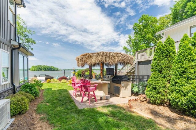 440 Sportsman Dr, Salisbury, NC 28146 - view of yard with stairs, a patio area, a water view, and an outdoor kitchen