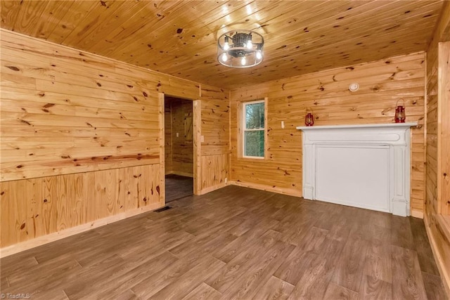 unfurnished living room with wood-type flooring, wooden ceiling, and wooden walls