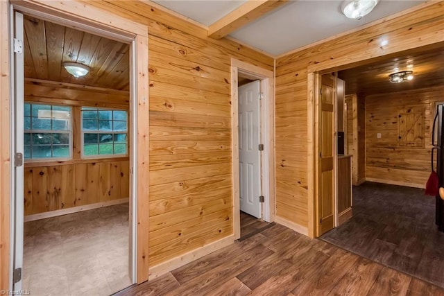 hall featuring wood-type flooring and wood walls