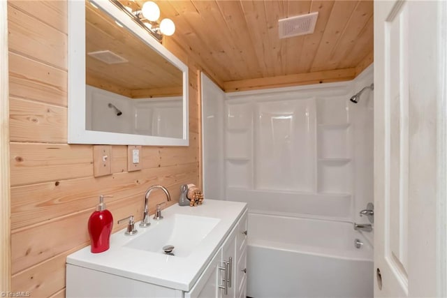 bathroom featuring wood walls, wood ceiling, vanity, and shower / bathing tub combination