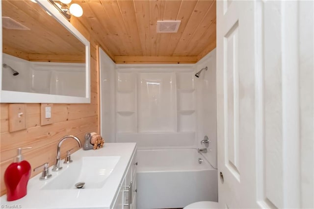 full bathroom with tub / shower combination, vanity, wooden ceiling, wooden walls, and toilet