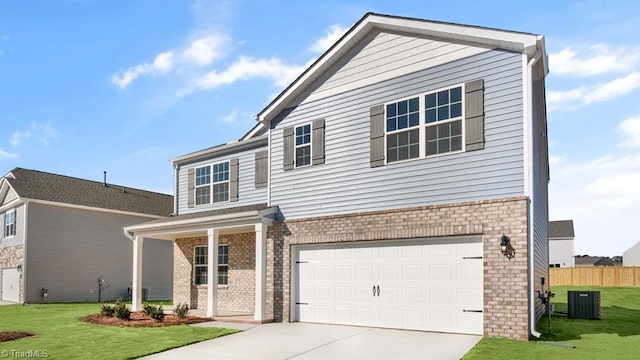 view of front facade with a front yard, central AC unit, and a garage