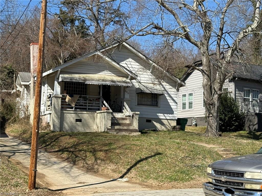 bungalow-style home featuring crawl space and a front yard