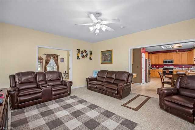 living room featuring light carpet and ceiling fan