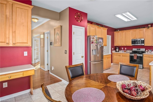 kitchen with ornamental molding, stainless steel appliances, and light brown cabinetry