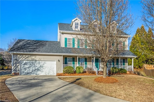 view of front of home with covered porch, a garage, and a front lawn