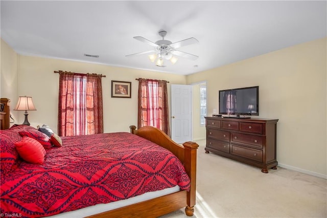 bedroom with ceiling fan and light colored carpet