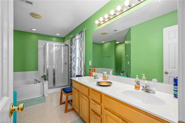 bathroom featuring tile patterned flooring, vanity, and separate shower and tub