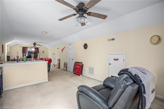 carpeted living room featuring ceiling fan and vaulted ceiling