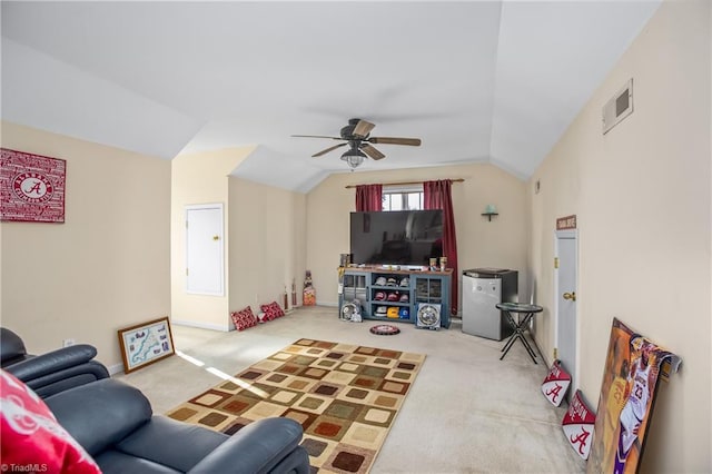 carpeted living room with ceiling fan and lofted ceiling